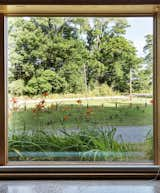 Outdoor, Front Yard, Grass, and Trees Romanzia rolling blinds extend from the floor to cover the Architectural Collection glazing by Eagle Windows.  Photo 5 of 8 in Cottage Industrious