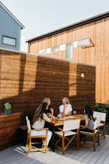 Outdoor, Back Yard, Front Yard, Side Yard, and Wood Fences, Wall Mary Jo Davis, Marja Preston, Jonathan Davis, and Tia Preston gather on the deck. “The community is the biggest selling point,” Preston says. “The icing on the cake is sustainability.”  Photos from It Takes a Village