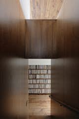 The adjacent volume houses the galley kitchen; the Ball clock is by George Nelson Associates.A portion of Jack’s massive collection of more than 10,000 records is displayed in a low-slung walnut shelving unit built along the upstairs stairwell entry.
