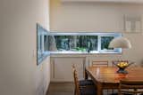 The dining area’s aluminum window frame was custom cut onsite to wrap around  a corner.