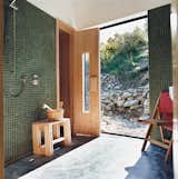 Bath Room and Concrete Floor Queenstown gets cold in winter, hence the installation of a sauna. Outside, the landscaping was kept deliberately casual, with rock walls and gravel paths.  Photo 2 of 7 in Drift Bay House by Dwell