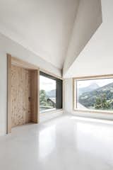 In contrast to the dark exterior, the interior is made of white concrete with aggregates of dolomite rock.