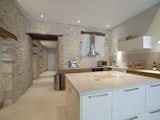 An apartment in the heart of the historical center of Beaune boasts a white kitchen.