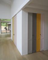 Playful panels of color on closet doors and the stair risers break up the white walls. The homeowner explains, “I took as inspiration Imi Knoebel, whose work I had seen at the Dia Beacon, and who works with large shapes of color placed in relationship to one another.” 