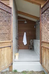 The home offers places for solitude and quiet. “Each bedroom was thought of as a separate building,” says the homeowner. “Each bathroom had an outdoor component.” Here, an outdoor shower is a private connection to the outdoors.