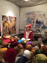 Shown here is a visitor in Fitzpatrick's art studio, where they house their collection of vintage feather hats from the mid-1950s to the 1970s—many of which are vintage Dior.&nbsp;