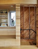 Stairwells and service areas utilize knotted planks. “It’s akin to stepping offstage into the wings,” resident Rhonda Rubinstein says of the transition.  Photo 6 of 12 in Sliding House by Dwell from Lights Will Guide You Home