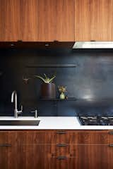 Subtly textured and tonal, a metal backsplash can be a great idea in a range of spaces, from industrial to moody and sombre.  In this particular kitchen, the backsplash and drawer pulls were fabricated by 12th Avenue Iron. The cooktop is by Miele.