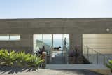 “Simple rectangular  volumes with simple details” is how designer Thomas Egidi describes the house he created for architect Carlos Dell’Acqua in Malibu. “I wanted to stress its horizontality,” Dell’Acqua notes. Inside the dwelling, which is entered via a bridge that pierces the 25-foot-high main facade, the view  opens up to a panorama of mountains and sea. Ipe flooring is used for the walkway and throughout the interior.
