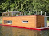 floating homes multilevel houseboat with wood siding and red trim