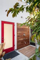 Designed for easy beachside living, “the cube” in the backyard—essentially the renovated garage—sports a sleek outdoor shower complete with a teak deck and Moen fixtures.