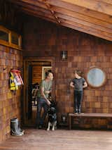 At the entrance, Bruce is joined by his son, Sozé, and dog, Izzy. The 1940s shingled cottage was renovated by architectural designer Randall Recinos, designer Brian Paquette, and contractor Dylan Conrad.