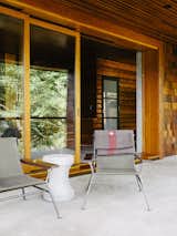 Outdoor, Back Yard, Front Yard, Side Yard, Hardscapes, and Concrete Patio, Porch, Deck Sling chairs by Garza Marfa flank  a Made Goods concrete table.  Photo 10 of 14 in Madrona by Dwell from An Eclectic Paciﬁc Northwest Cottage