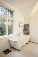 Bath Room, Freestanding Tub, Soaking Tub, and Ceramic Tile Floor The footed bathtub in the completely renovated bathroom is by Marc Newson for Caroma.  Photos from This New Old House