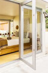 Custom folding doors, inspired by Rudolf M. Schindler’s 1930 Elliot House, were created by Rene Maya to Andrew’s specifications.
