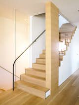 The staircase  follows the bedroom’s new primary material, French white oak.