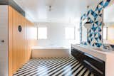 Architect Barbara Bestor added a striped floor of Santander Granada Tile, Douglas fir cladding, and Granada Serengeti tile flipped to create a one-of-a-kind pattern on the wall.