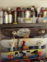 In the music room, skateboards are stored below spray paints the family and friends use to decorate the skate bowl.