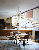 Mostly they restored original elements, like the buffet and the staircase. Cherner chairs sit at the head of a Design Within Reach table. The armless Series 7 chairs are by Arne Jacobsen; the third pair are Juliana chairs by Aristeu Pires.