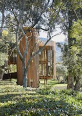 In the lush Constantia Valley of Cape Town, South Africa, sits a floating cabin designed by Malan Vorster Architecture as a retreat on a family estate. Made of glass, steel, and vertical timber slats, the lofted hideaway is thoughtfully tucked away in the trees to enhance the feeling of getting away.