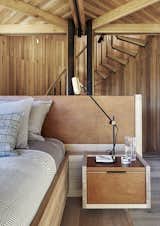 Like the built-in bed, nightstands, headboard, and other custom furniture, the staircase leading to the open-air viewing platform was made by Versfeld. The Lektor desk lamps are by Rubn.