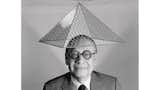 I.M. Pei with a model of Le Grand Louvre on his head.