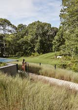 “I really wanted to explore the potential of the property, because the original house was probably using one-tenth of its capacity,” says Masi, who also conceived the landscape and lighting design. He selected native grasses and other plantings for their ability to move with the wind.