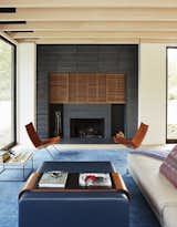 Living Room, Chair, Sofa, Coffee Tables, Ottomans, and Wood Burning Fireplace  Photo 5 of 9 in Promised Land by Dwell
