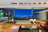 Living Room, Ceiling Lighting, Sofa, Coffee Tables, and Medium Hardwood Floor  Photo 3 of 16 in Pierre by Benigeri from ‘Friends’ Star Matthew Perry’s Midcentury Stunner in the Hollywood Hills Is For Sale