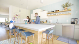 Kitchen, Pendant Lighting, Colorful Cabinet, and White Cabinet “Sometimes you catch hilarious moments when you’re watching them with Nest Cam IQ,” says Cameron.*  Photo 5 of 8 in Revamping the San Francisco Vernacular, Modern Design and Technology Serves A Busy Family
