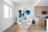 Dining Room, Table, Pendant Lighting, and Concrete Floor The dining room is outfitted with a pair of striking paintings by Vivian Caits.  Photo 2 of 7 in St. Barts-Inspired Tilley Row Home by Dwell from St. Barts-Inspired Accents Create Modern Tranquility in an Austin Tilley Row Home