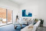 Living Room, Chair, Lamps, End Tables, Sofa, Coffee Tables, Concrete Floor, and Floor Lighting  Chase Daniel’s Saves from St. Barts-Inspired Accents Create Modern Tranquility in an Austin Tilley Row Home