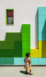 The facade of the building, which is known as “The Tetrisception,” is decorated with a series of 17.5-inch-square plastered brick cubes, a low-cost design technique.  Photo 2 of 2 in A Dilapidated Home in New Delhi Is Transformed Into a School That Fosters Creativity