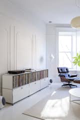To make the interior of their 12-foot-wide Brooklyn home feel larger, designers Ed Parker and Barbara Tutino Parker used Farrow &amp; Ball paint in All White for the floors and applied Benjamin Moore Super White with a flat finish to the walls. They also rearranged the floor plan.