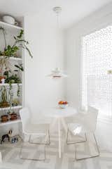 In the kitchen, a PH 50 pendant by Poul Henningsen for Louis Poulsen hangs overhead; the window is covered in a decorative cast-iron metal security grate from King Architectural Metals. The painted patterned floor is by Lillian Heard Studio.
-
Brooklyn, New York
Dwell Magazine : July / August 2017  Photo 8 of 13 in A Pair of Designers Renovate Their Brooklyn Brownstone With a Bright Monochromatic Palette