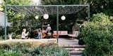 Outdoor, Back Yard, Side Yard, Trees, Boulders, Stone Patio, Porch, Deck, Hanging Lighting, and Walkways  Agnieszka Jakubowicz’s Saves from A Laser-Cut Pergola Completes a Tranquil Garden in L.A. That’s Perfect For Entertaining