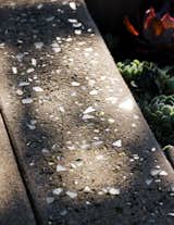 The pieces of crushed glass embedded in the poured concrete beneath the canopy were hand selected by Montalvo and her client.
