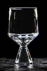 The finished product, the Westport footed glass, is shown here fresh from the lehr, a temperature-controlled kiln that slowly cools the glass over an 8-to-10-hour period. The piece, which was created by design director James Murray in 2013, is a top performer for the company. Murray notes, “It has so much more action and warmth than machine-made glass.”  Photo 5 of 17 in Inside Master Glassmaker Simon Pearce’s Sustainable Factory in Vermont