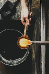 Blocking 
Next, the honey-like material is blocked, or centered and cooled, using a cherry wood tool kept wet in a pail of water. The process keeps the glass from becoming too “wobbly.”  Photo 9 of 17 in Inside Master Glassmaker Simon Pearce’s Sustainable Factory in Vermont