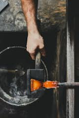 Molding 
A cherry wood mold is used to shape  the base of the glass. The mold is made in-house,  as are all the factory’s tools.  Photo 10 of 17 in Inside Master Glassmaker Simon Pearce’s Sustainable Factory in Vermont