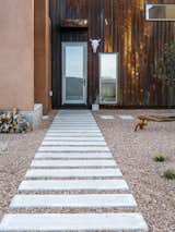 Rusted metal, used on three of the home’s five roofs, extends to the entrance facade, which, in a nod to northern New Mexico’s haciendas, opens to a courtyard. Rather than buy pre-rusted siding, Molly and her father oxidized the steel themselves.
-
Taos, New Mexico
Dwell Magazine : July / August 2017