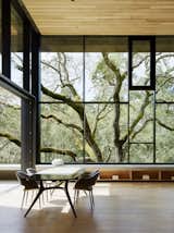 Located in Orinda, California, a three-bedroom house by architect Greg Faulkner took its first aesthetic cue from a large oak tree on the site. Cor-Ten steel panels clad the exterior, while white oak offers a material counterpoint on the interior. A 12-foot-wide sliding pocket wall opens the living/dining area to a terrace. DZINE Concept did the interior design throughout. The dining room features a Liquid table by Baxter and Charme chairs from Busnelli. &nbsp; &nbsp;