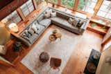 Living Room, Coffee Tables, End Tables, Console Tables, Lamps, Table Lighting, and Medium Hardwood Floor  Photo 1 of 47 in furniture by Hog Island Woodcraft from Repurposed Ship Materials and 100-Year-Old Beams Make Up This Tree House-Like Home