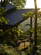 Outdoor and Wood Patio, Porch, Deck The cold-rolled corrugated-steel roofing from B&amp;M Metals will gradually rust, achieving a weathered look.


Scaly Mountain, North Carolina
Dwell Magazine : September / October 2017  Photo 11 of 45 in Porch by Casey Tiedman from A Rustic-Modern Cabin Inspired by Japanese Bungalows and Shou Sugi Ban