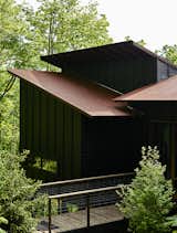 Referring to the design aesthetic as "Japanese rustic modern," this 1,000-square-foot summer home in Asheville, Georgia, by ASD/Sky was inspired by wooden bungalows they saw during a trip to Kyoto, Japan. The exterior's stained-pine boards were intended to mimic the look of traditional shou sugi ban, where the outer layer of wood is charred to protect it from rot and fire.