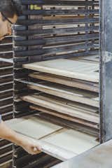 Drying:  Damp tiles go in an industrial dryer for about 12 hours to remove excess moisture before their ﬁrst ﬁring at nearly 2,000 degrees. Once fired, tile is called “bisque.”  Photo 10 of 14 in Go Behind the Scenes With a Process-Driven Handmade-Tile Company in California