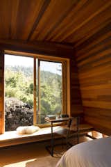 Windows, Sliding Window Type, and Wood Detailed in cedar paneling and plywood, Mauka was oriented to catch the sunrise. The table is by Moore’s firm, FLOAT.

Maui, Hawaii
Dwell Magazine : September / October 2017  Photo 4 of 10 in living room by Yuan Zhou from Two Tiny Pavilions Respectfully Perch Atop a Lava Flow on Maui
