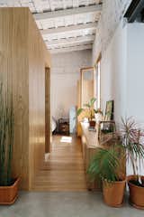 Hallway and Medium Hardwood Floor A box sheathed  in the same material acts as a divider and holds the bathroom.
-
Buenos Aires, Argentina
Dwell Magazine : September / October 2017  Photos from An Architect Turns His Small, Dark Apartment in Buenos Aires Into a Bright and Airy Home