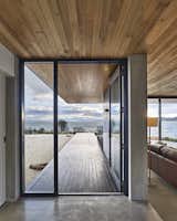 The dwelling’s concrete slab meets a New Zealand pine deck at the custom steel entrance door.

Tasmania, Australia
Dwell Magazine : September / October 2017