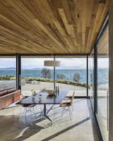 The dining table and chairs are by Charles and Ray Eames. The ceiling, which extends beyond the building’s envelope, is made of Tasmanian oak.

Tasmania, Australia
Dwell Magazine : September / October 2017